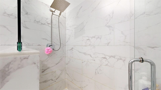 bathroom with tiled shower