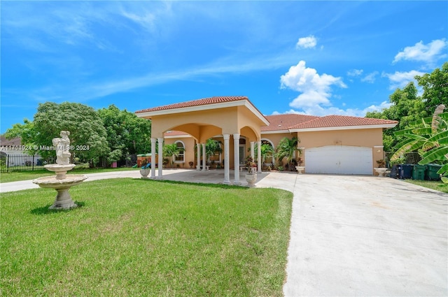 mediterranean / spanish house featuring a garage and a front lawn