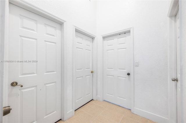 hall featuring light tile patterned floors