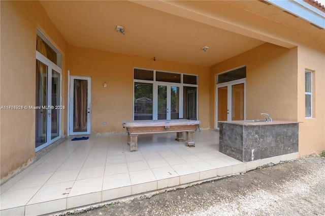 view of patio / terrace featuring sink and french doors