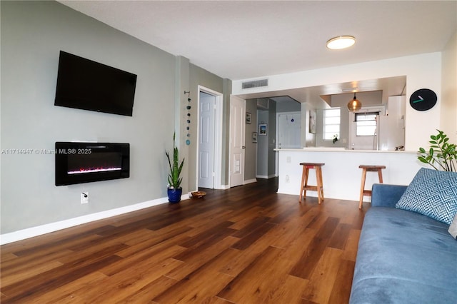 unfurnished living room with dark hardwood / wood-style floors