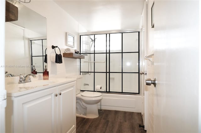 full bathroom featuring vanity, toilet, combined bath / shower with glass door, and wood-type flooring