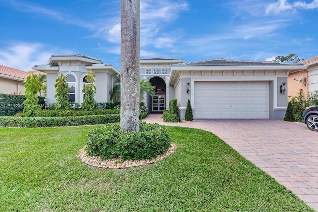 view of front of home featuring a front lawn and a garage