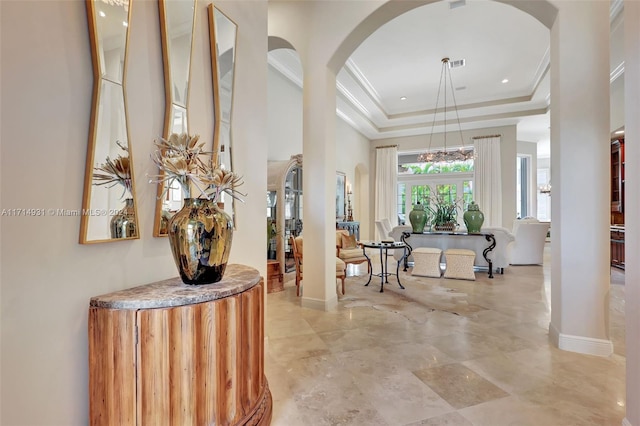 hallway featuring a tray ceiling and crown molding