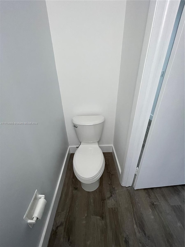 bathroom featuring toilet and wood-type flooring