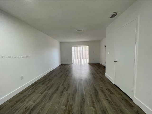 spare room featuring dark wood-type flooring