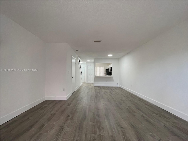 unfurnished living room featuring dark wood-type flooring