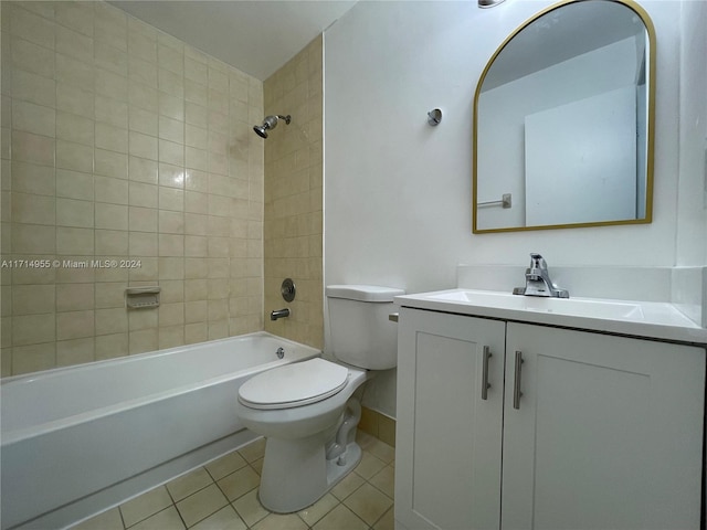 full bathroom featuring tiled shower / bath, tile patterned flooring, vanity, and toilet