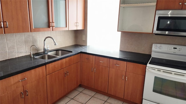 kitchen with sink, light tile patterned floors, decorative backsplash, and white electric range oven