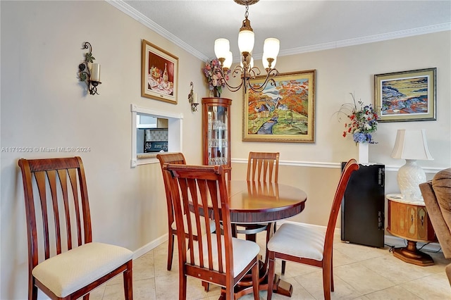 tiled dining space featuring a notable chandelier and ornamental molding