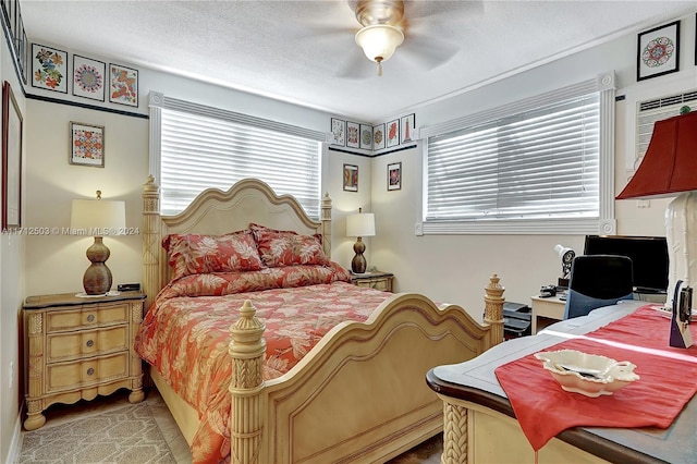 tiled bedroom featuring ceiling fan and multiple windows