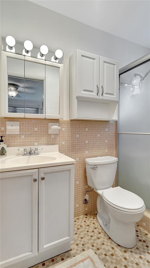 16750 NE 14th Ave Unit 212, Miami, FL 33162 - bathroom featuring vanity, tile walls, a shower with shower door, and tile patterned flooring