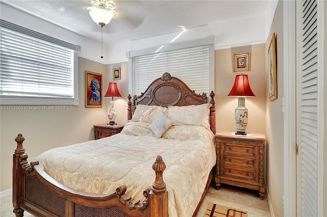 tiled bedroom with ceiling fan