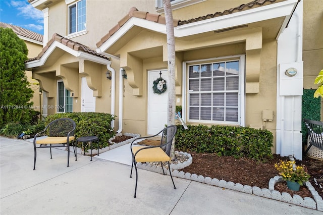 view of exterior entry featuring a patio