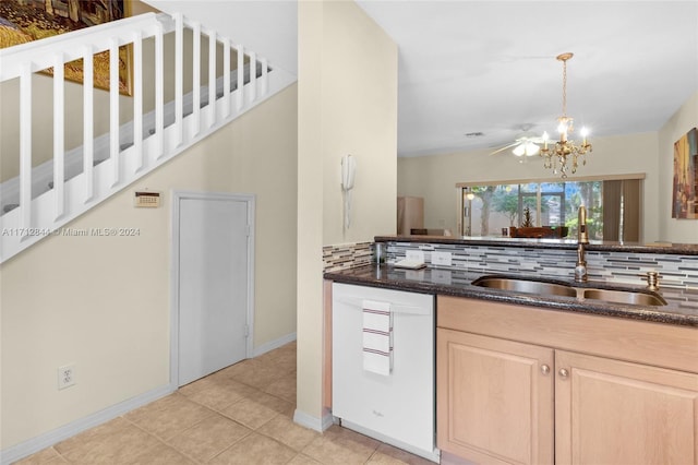 kitchen with pendant lighting, light brown cabinets, dark stone counters, sink, and decorative backsplash