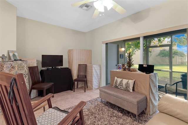 tiled living room with a wealth of natural light and ceiling fan