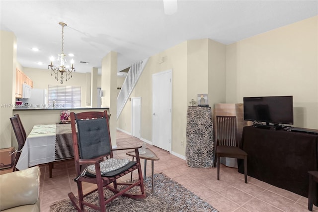 tiled dining area featuring a notable chandelier