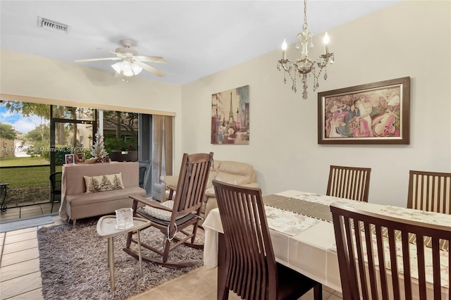 dining area with ceiling fan with notable chandelier and light tile patterned floors