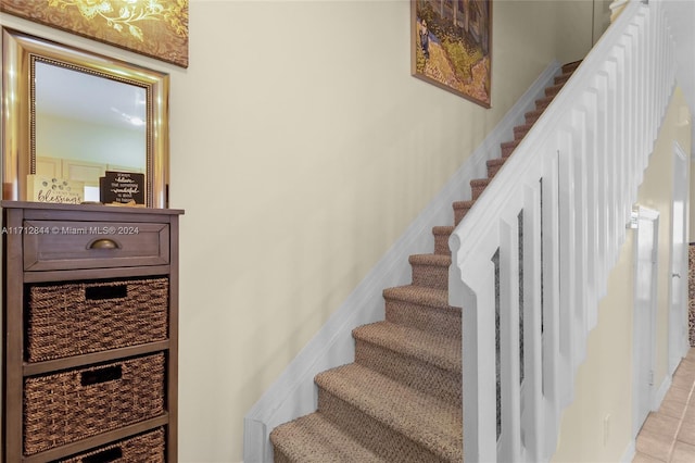 stairway featuring tile patterned flooring