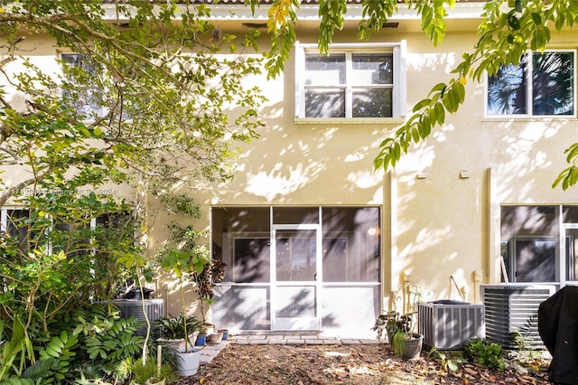 rear view of property with central AC unit