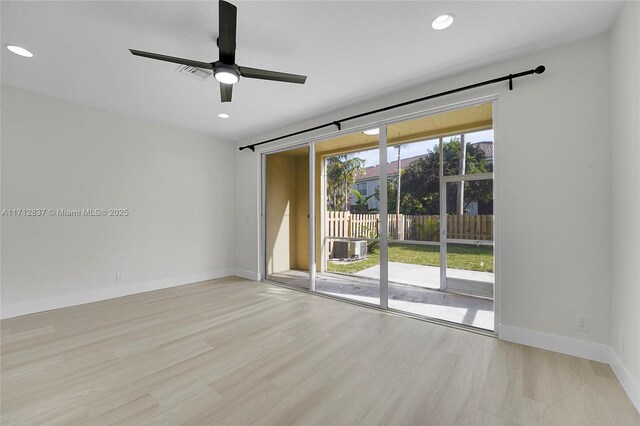 spare room featuring ceiling fan and light wood-type flooring