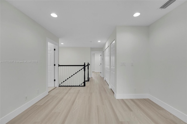 corridor featuring light hardwood / wood-style floors