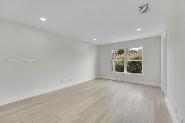 bathroom with vanity, a shower with door, toilet, and a wealth of natural light