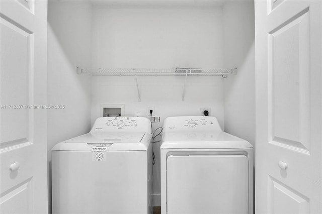 laundry room featuring washing machine and dryer