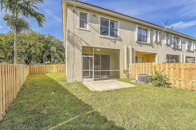 back of property featuring a patio area, central air condition unit, and a yard