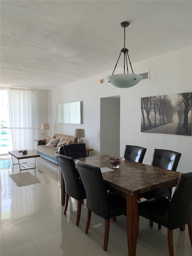 dining area with light tile patterned floors