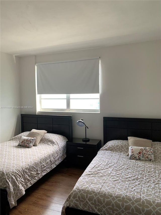 bedroom with dark hardwood / wood-style floors