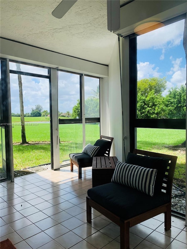 sunroom featuring ceiling fan