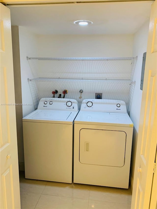 laundry area featuring independent washer and dryer and light tile patterned floors