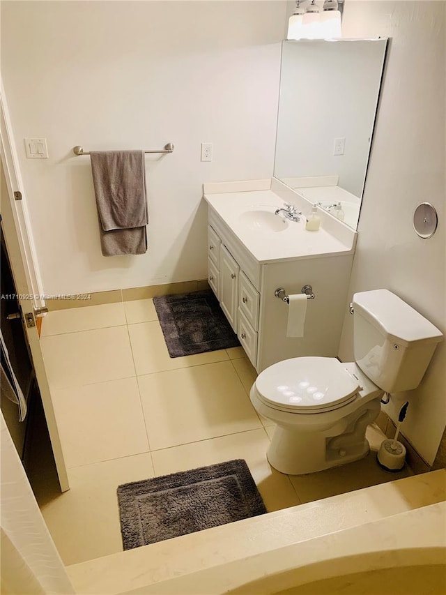 bathroom featuring toilet, vanity, and tile patterned floors