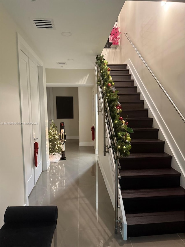 staircase featuring tile patterned flooring and french doors