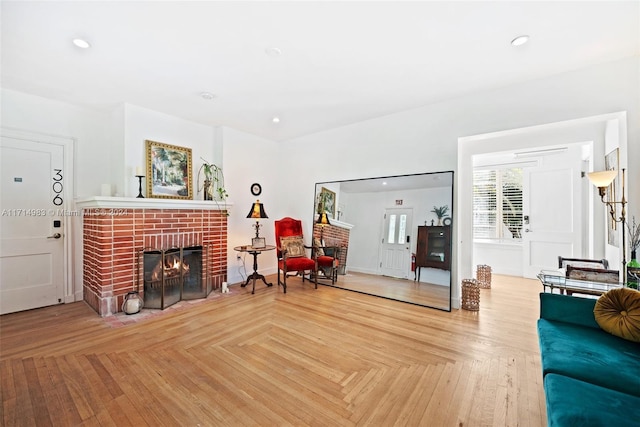 living room with parquet floors and a brick fireplace