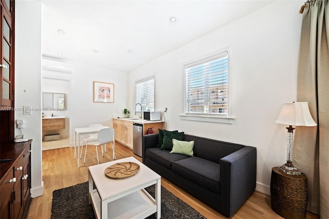 living room with sink and light hardwood / wood-style floors