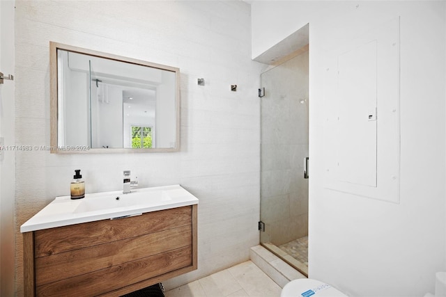 bathroom featuring tile patterned floors, electric panel, vanity, and walk in shower