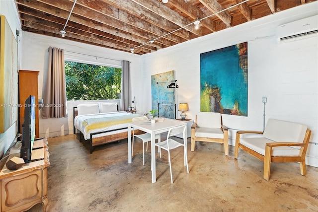 bedroom featuring a wall mounted air conditioner and concrete floors