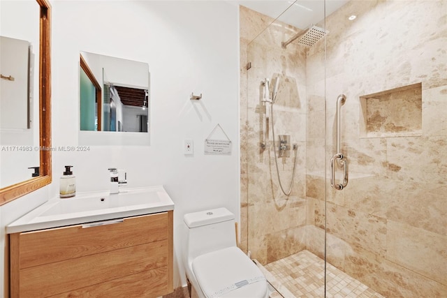 bathroom with vanity, toilet, and a shower with door