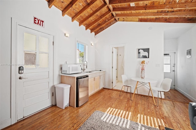 kitchen with refrigerator, sink, light wood-type flooring, beamed ceiling, and wood ceiling