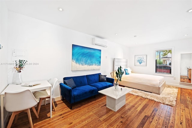 bedroom featuring a wall unit AC and wood-type flooring