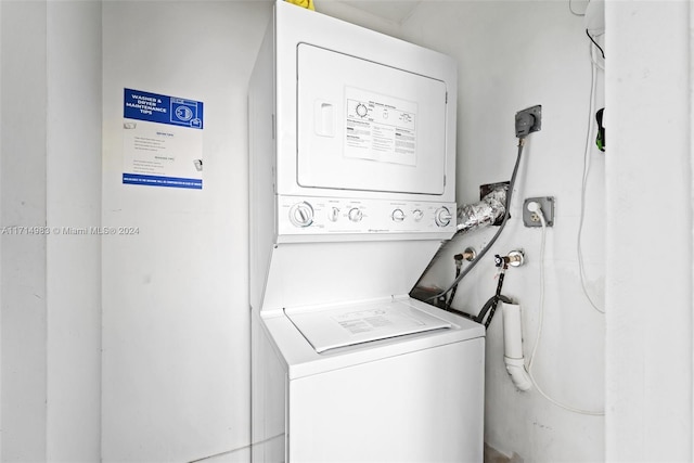 clothes washing area with stacked washer / drying machine