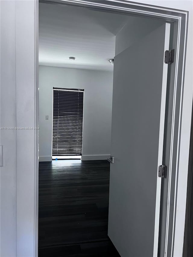 empty room featuring dark hardwood / wood-style flooring