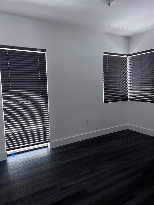 unfurnished room featuring dark hardwood / wood-style flooring