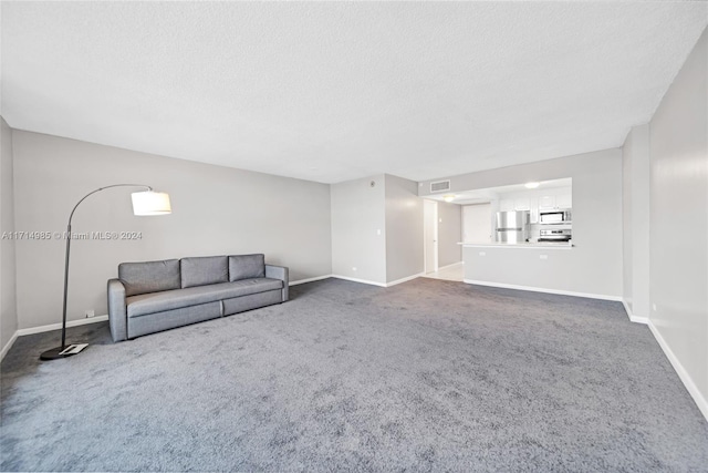 unfurnished living room featuring carpet floors and a textured ceiling