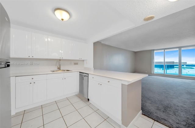 kitchen featuring kitchen peninsula, light carpet, stainless steel dishwasher, sink, and white cabinetry