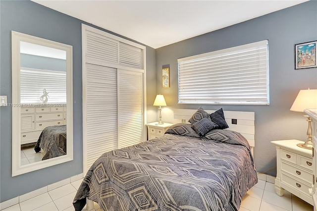 bedroom featuring a closet and light tile patterned flooring