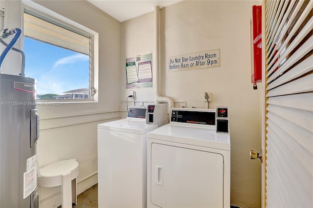 laundry room featuring washing machine and dryer and water heater