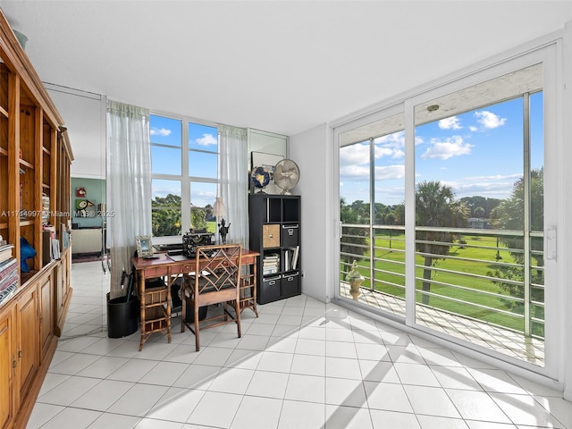 tiled dining space featuring a wall of windows